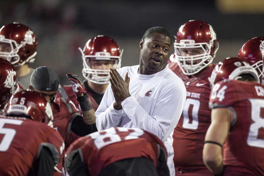 Dennis Simmons speaks to players during his stint as wide receivers coach at Washington State in 2013.
