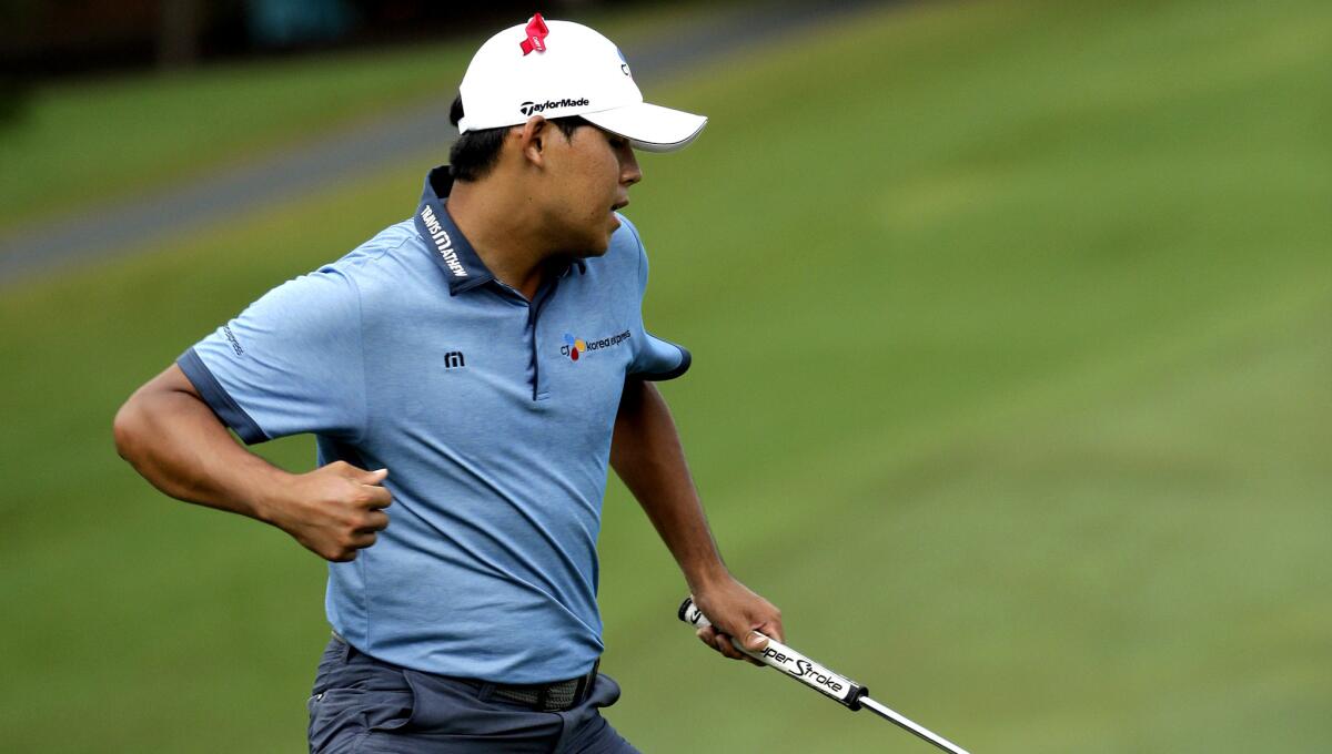 Si Woo Kim reacts Sunday after sinking a birdie putt on No. 18.