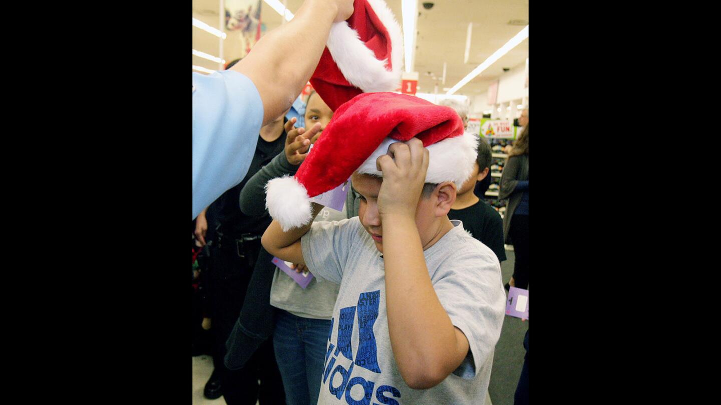 Photo Gallery: Boys and Girls Club of Burbank and Burbank Police Department work together shop for Christmas gifts at Kmart