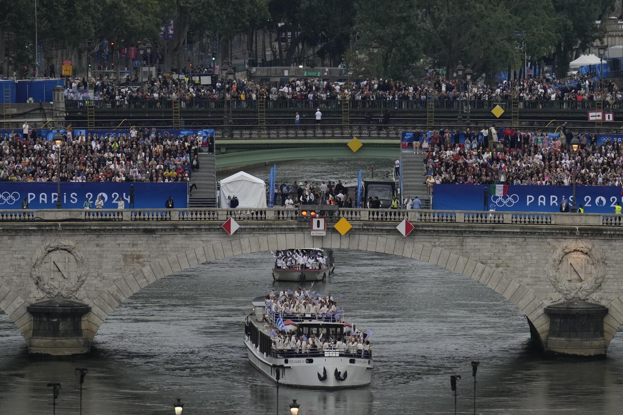 Team Greece on a boat going under a bridge on the Seine.