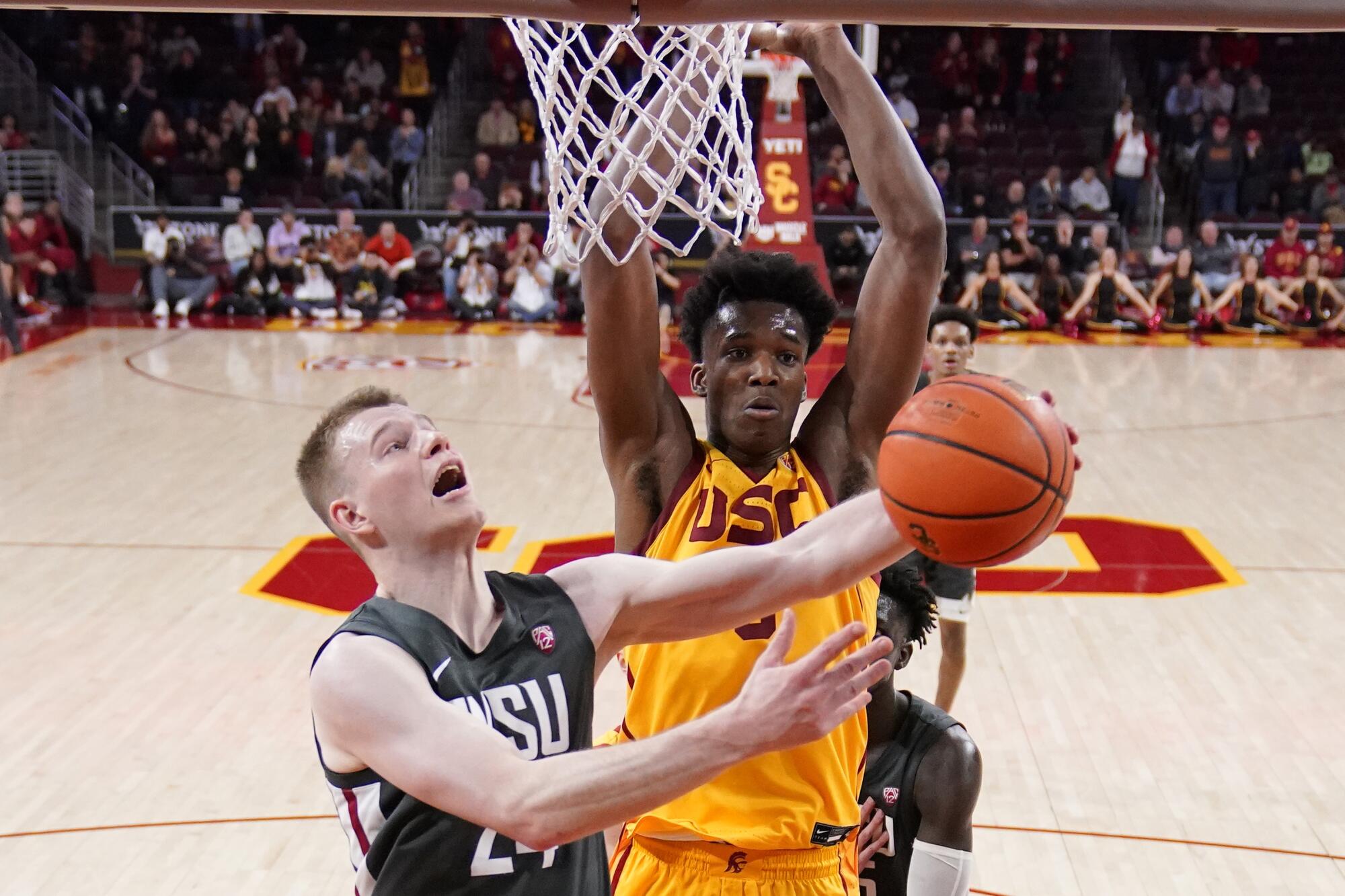 Washington State guard Justin Powell tries to shoot in front of USC forward Vincent Iwuchukwu