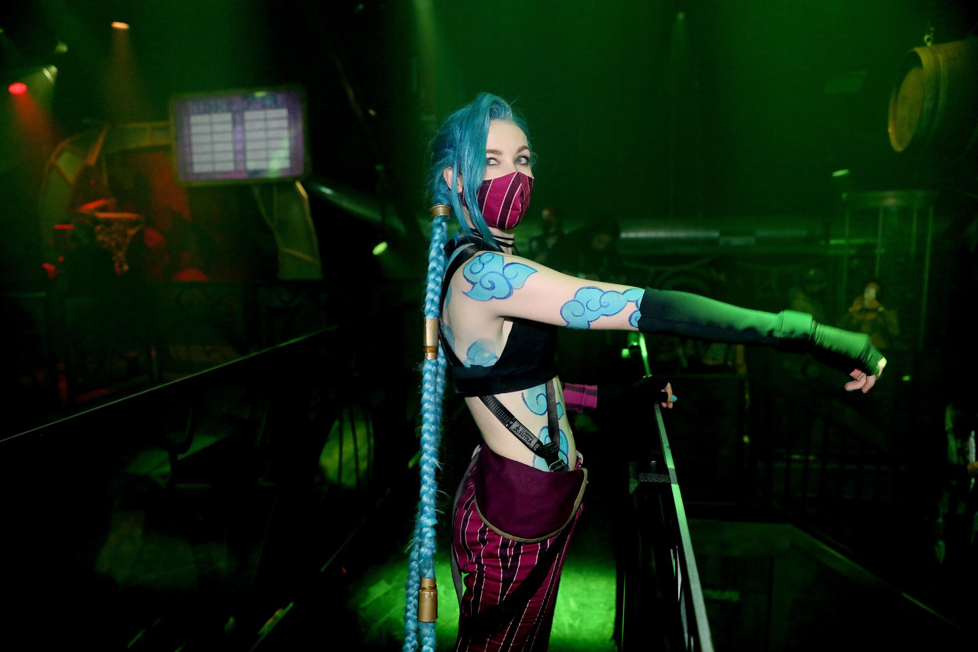 A women with long blue braids in a video game-inspired costume.