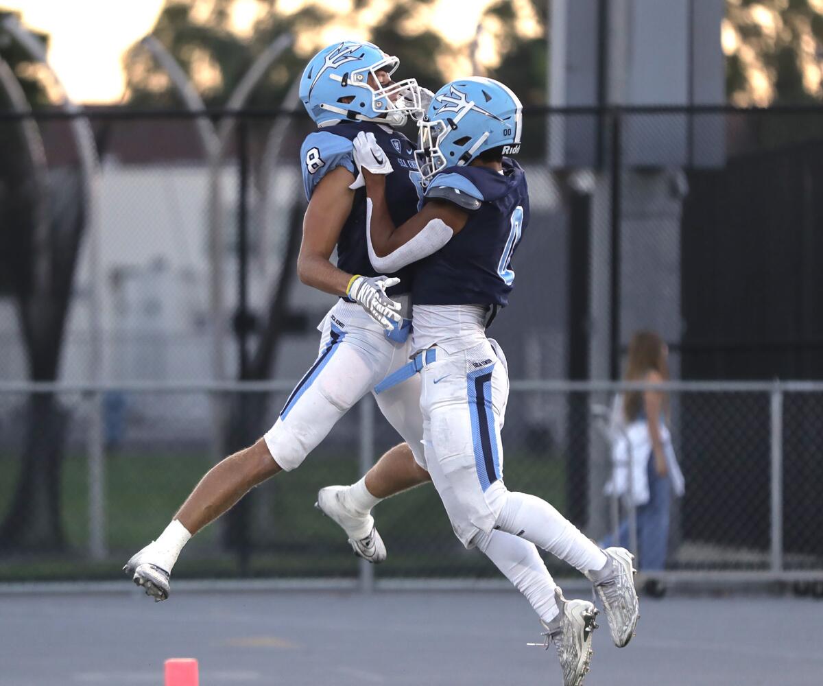 Corona del Mar receiver Russell Weir (8) celebrates in the end zone with teammate Dorsett Stecker against Cypress on Friday.
