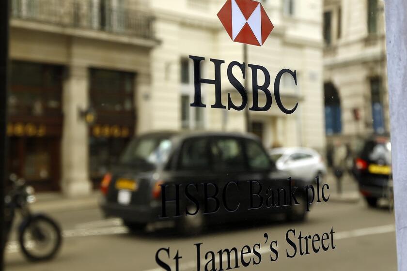 A taxi drives past an HSBC plaque in London on June 9.