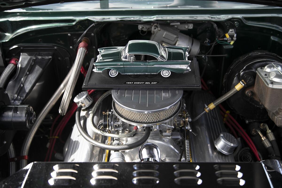 A model car replica of a 1957 Chevy Bel Air placed atop the engine at the 20th annual Beachcruisers event on Saturday.