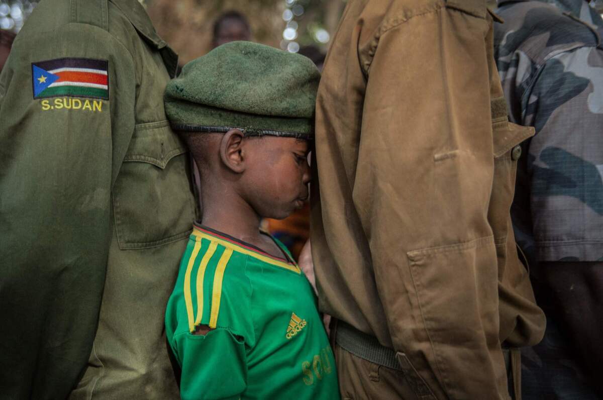 Newly released child soldiers wait in a line for their registration during the release ceremony in Yambio, South Sudan.