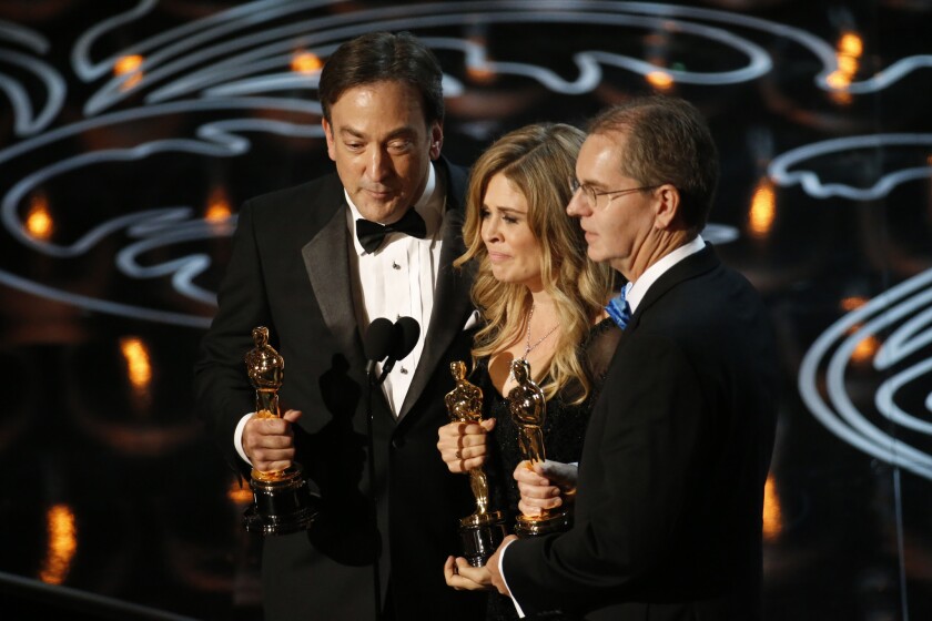 Peter Del Vecho, left, Jennifer Lee and Chris Buck accept the Oscar for best animated feature for "Frozen" last year.