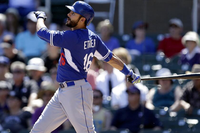 Dodgers outfielder Andre Ethier, who will probably begin the season as a reserve, watches his two-run home run against Rockies during an exhibition game March 21.