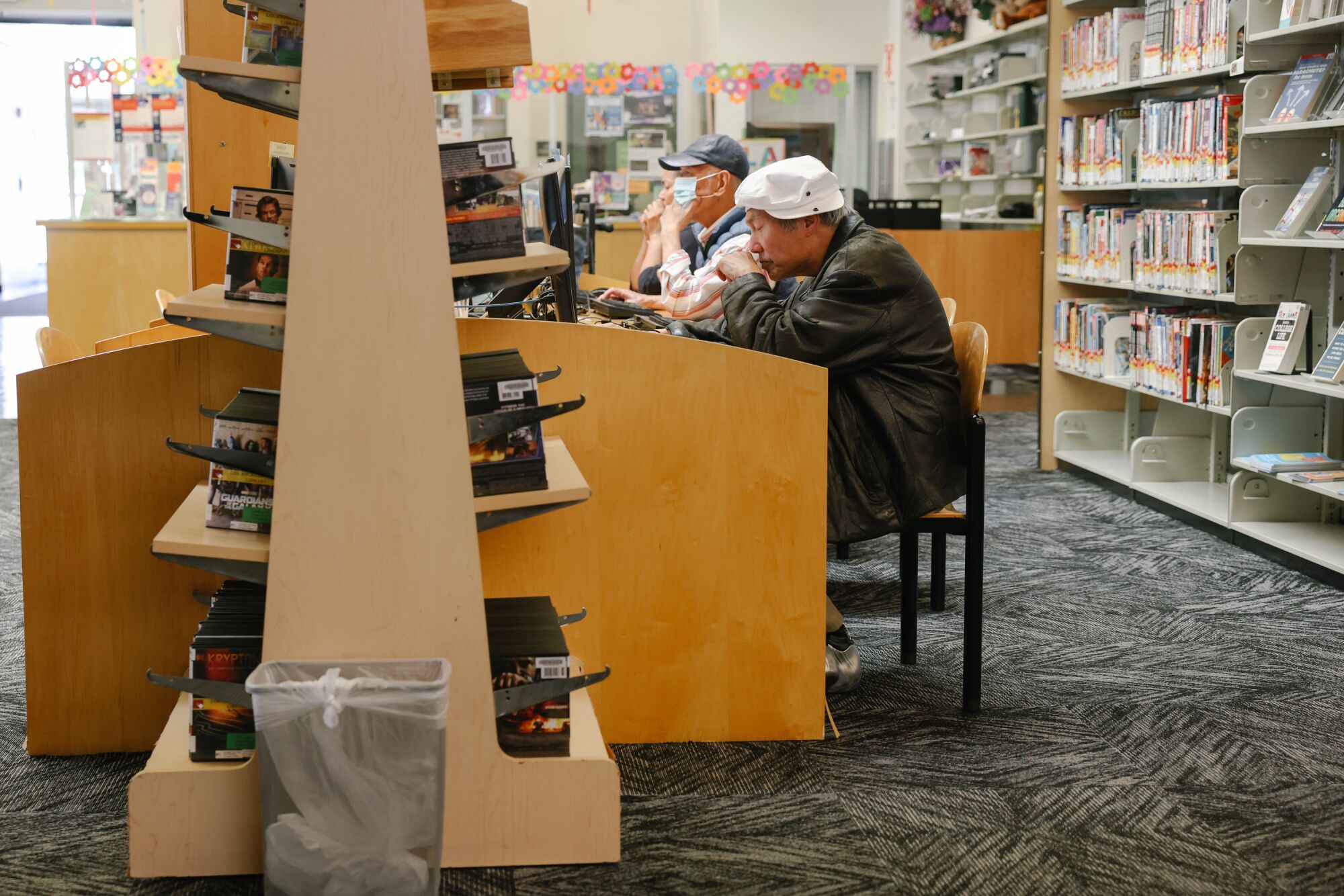 People utilize the shared computer spaces at the Chinatown Branch 
