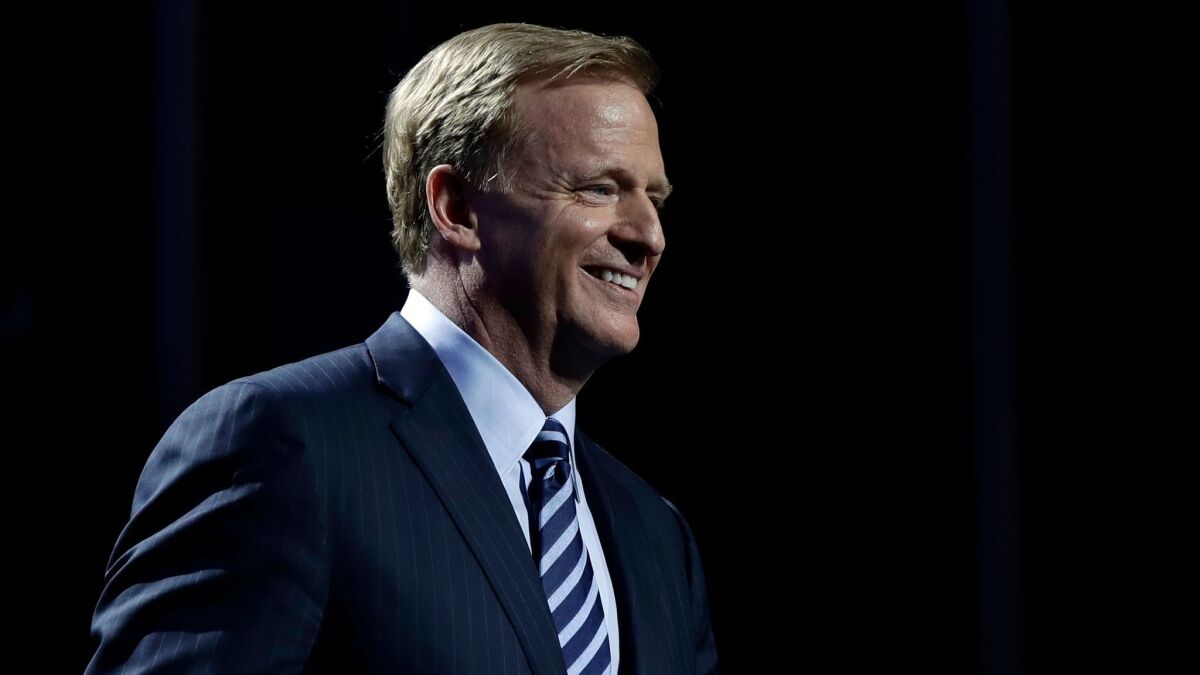 Commissioner Roger Goodell smiles as he walks onstage during the first round of the NFL draft on April 27.