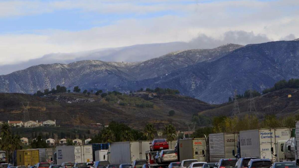 A recent ruling is a victory for a contingent of trucking businesses that had complained the state air board created an uneven playing field with a 2014 vote. Above, trucks wait in traffic on the 5 Freeway near Castaic.