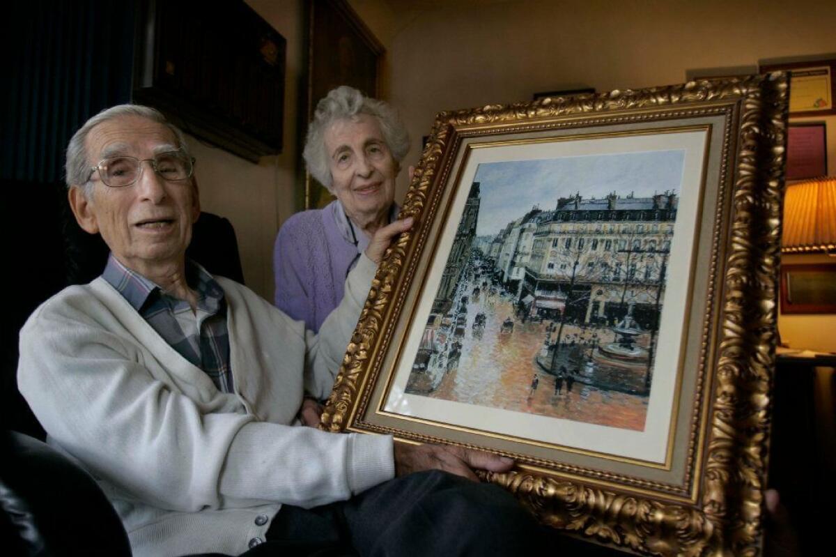 La Mesa resident Claude Cassirer and his wife of 66 years, Beverley, with a copy of the Camille Pissarro painting that the Nazis took from his grandmother. Before his death in 2010, Cassirer sought the return of the painting from a museum in Spain.