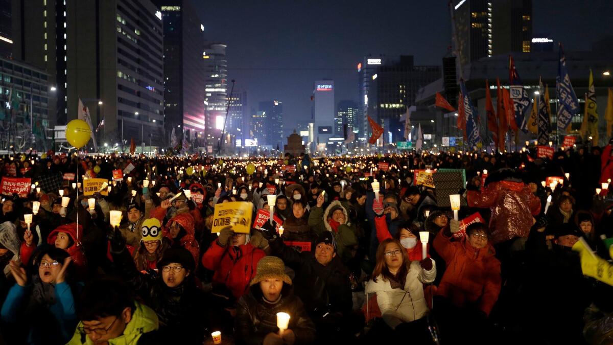 Protesters holding a candlelight vigil in Seoul on Jan. 21, 2017, call for impeached President Park Geun-hye to step down.