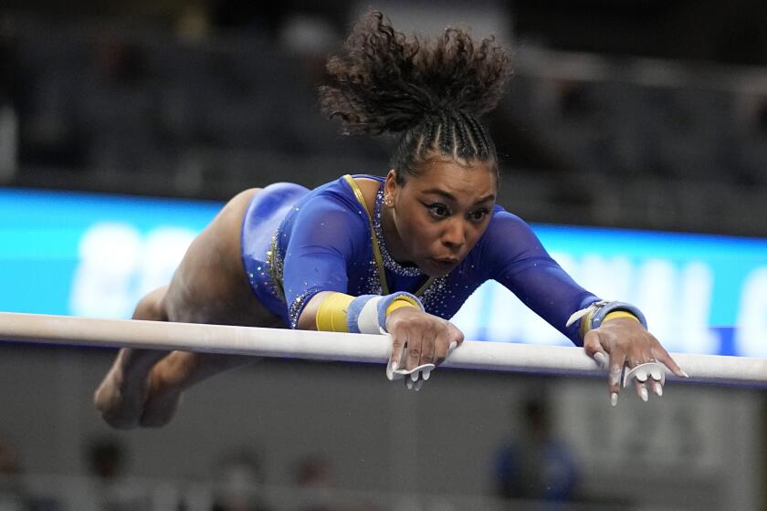 UCLA's Margzetta Frazier competes on the uneven bars during the semifinals.