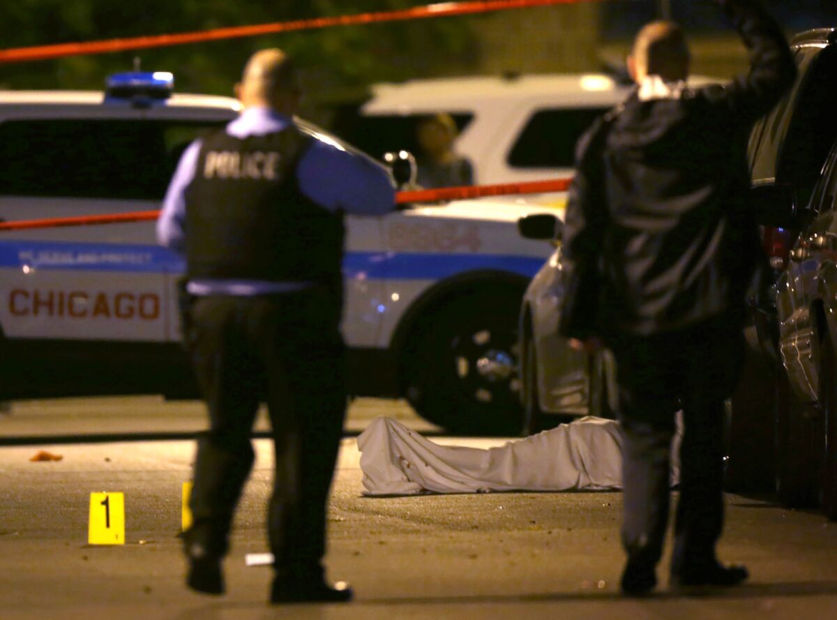 Chicago police work the scene where a man was fatally shot in the chest in the Washington Park neighborhood on May 30. Violent crimes are on the rise in many major U.S. cities so far this year.