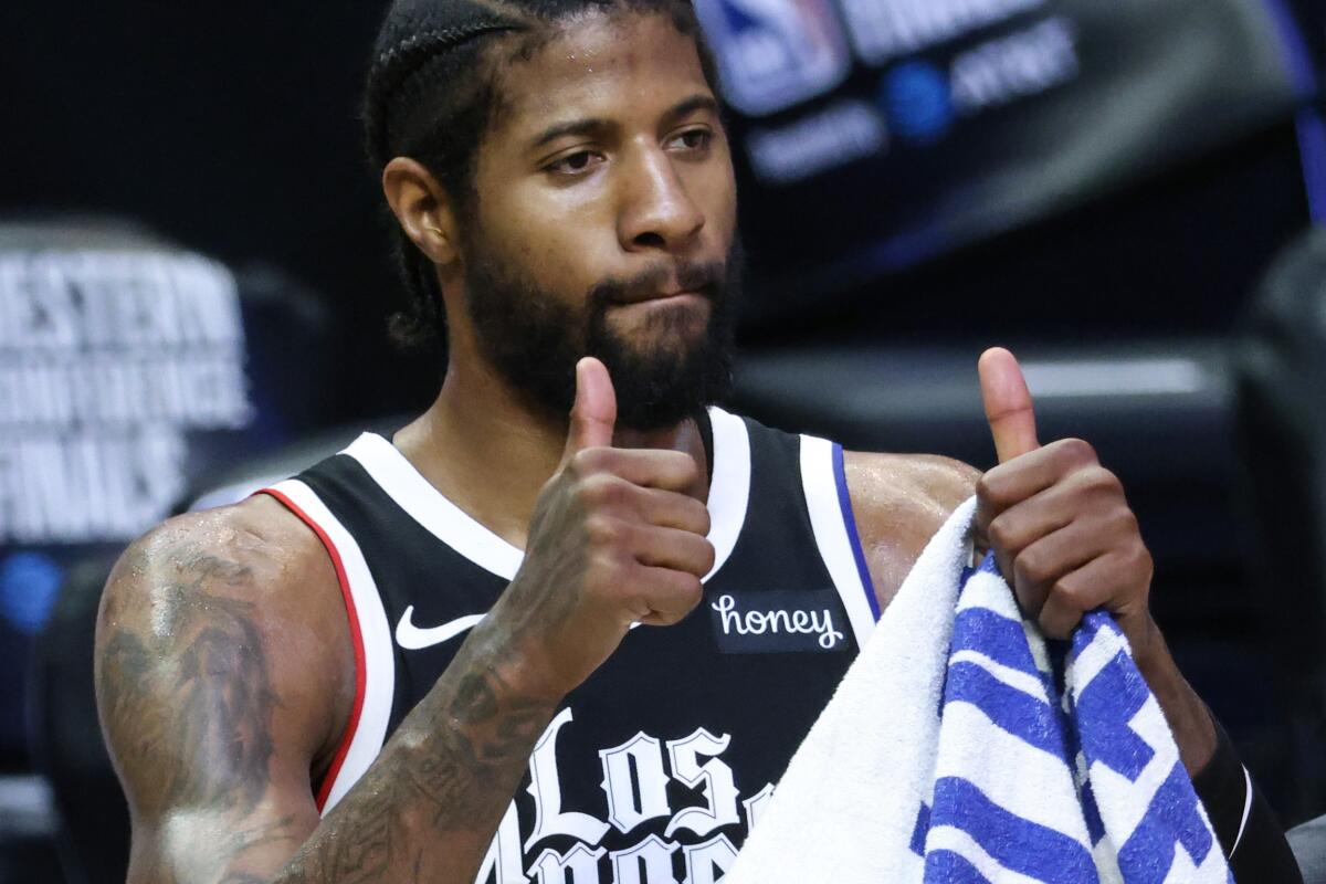 Paul George flashes the thumbs up sign to fans after the Clippers beat the Phoenix Suns.
