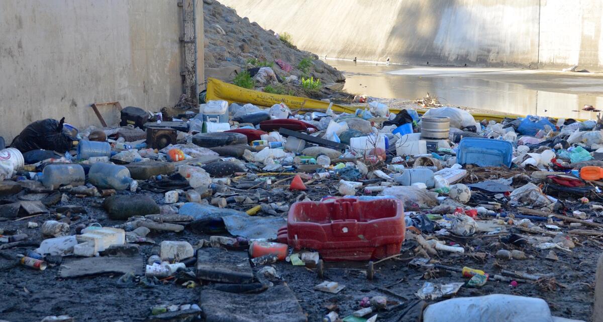 The Santa Ana Delhi River Channel waterway is cluttered with debris in less than a month after cleanup.