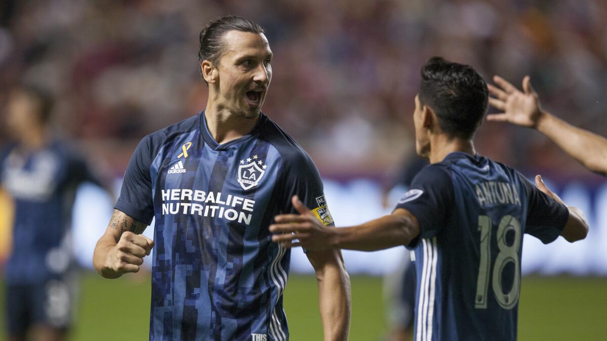 Galaxy forward Zlatan Ibrahimovic celebrates with teammate Uriel Antuna after scoring a goal.