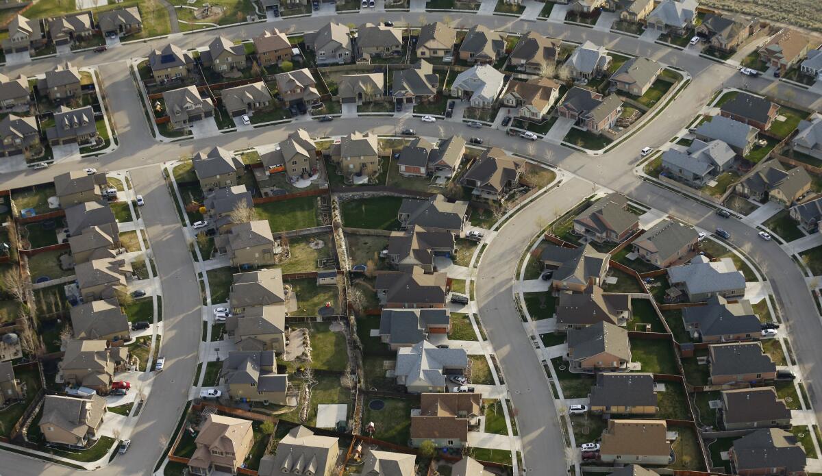 Homes and intersecting streets in a residential neighborhood are seen from above.