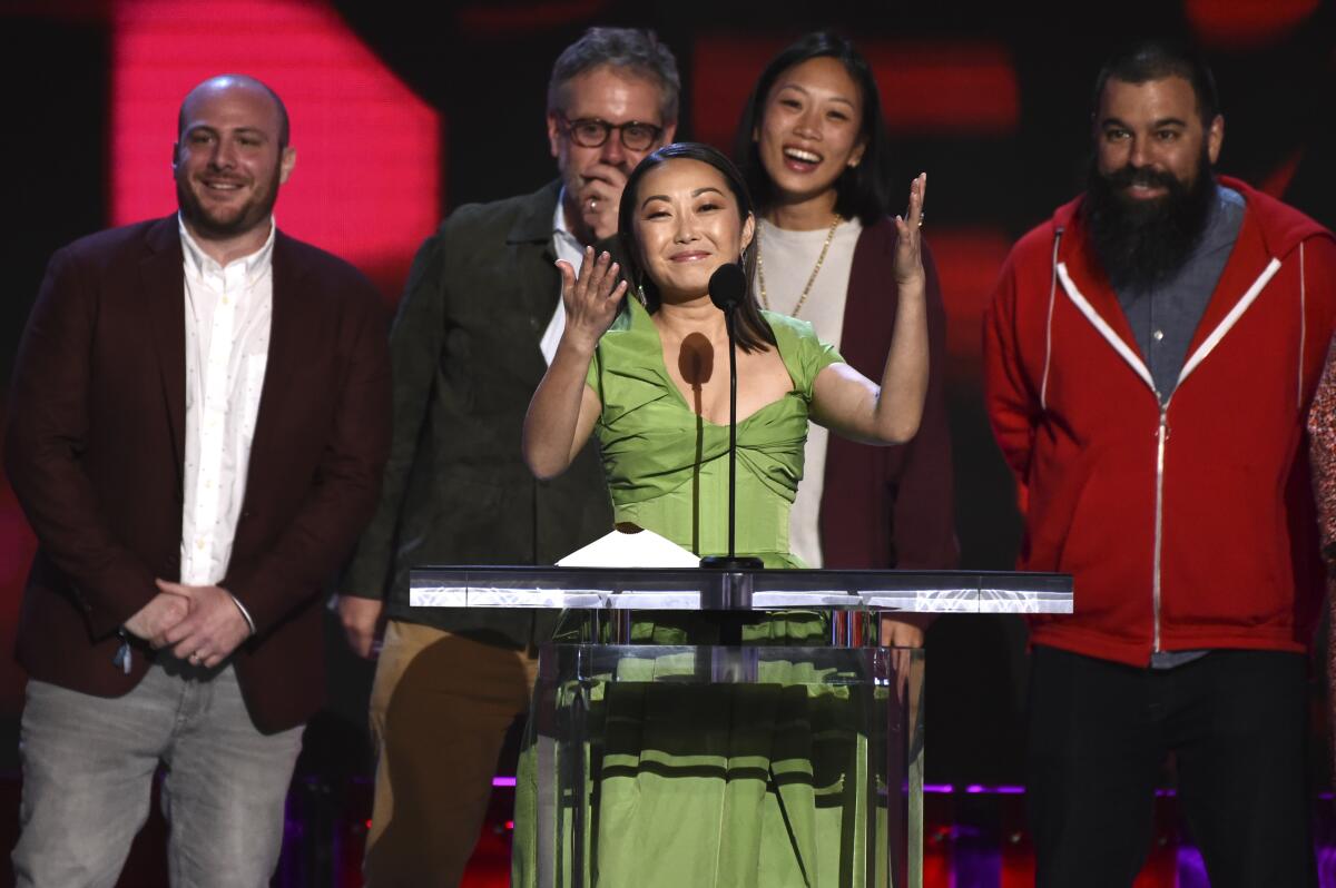 Lulu Wang, center, accepts the award for best feature for "The Farewell" at the 35th Film Independent Spirit Awards on Saturday, Feb. 8, 2020, in Santa Monica, Calif. Eddie Rubin, from left, Peter Saraf, Anita Gou, and Andrew Milano look on.