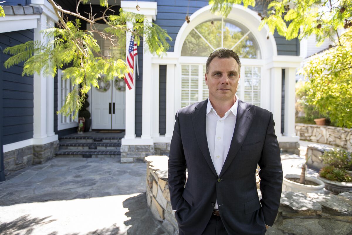 Huntington Beach city attorney Michael Gates stands outside his home on Aug. 17.