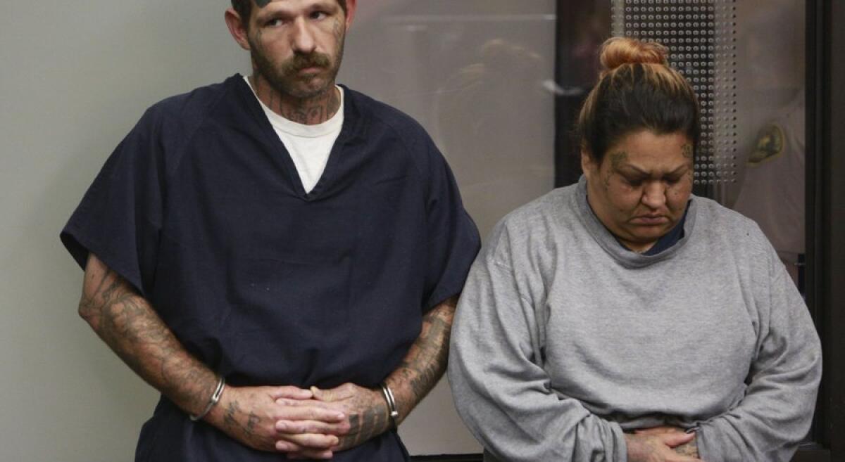 Defendants Johnny Lewis Hartley and Mercy Mary Becerra stand before a judge at a San Diego courthouse in August.