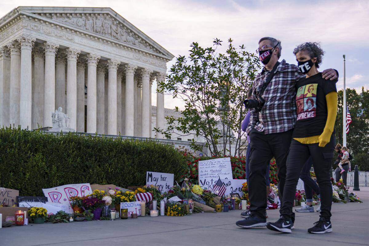 People gather outside the Supreme Court to mourn Justice Ruth Bader Ginsburg on the morning after her death.