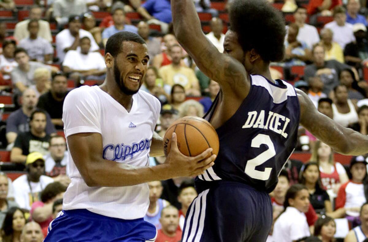 Clippers forward Brandon Davies drives to the basket against Hawks forward Ed Daniel in the fourth quarter of an summer league game.