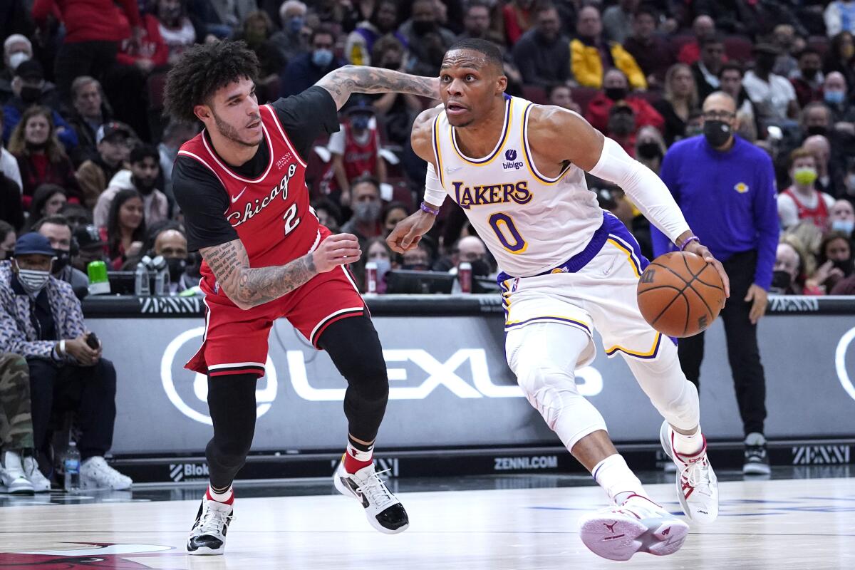 Lakers guard Russell Westbrook, right, drive to the basket against Chicago Bulls guard Lonzo Ball.
