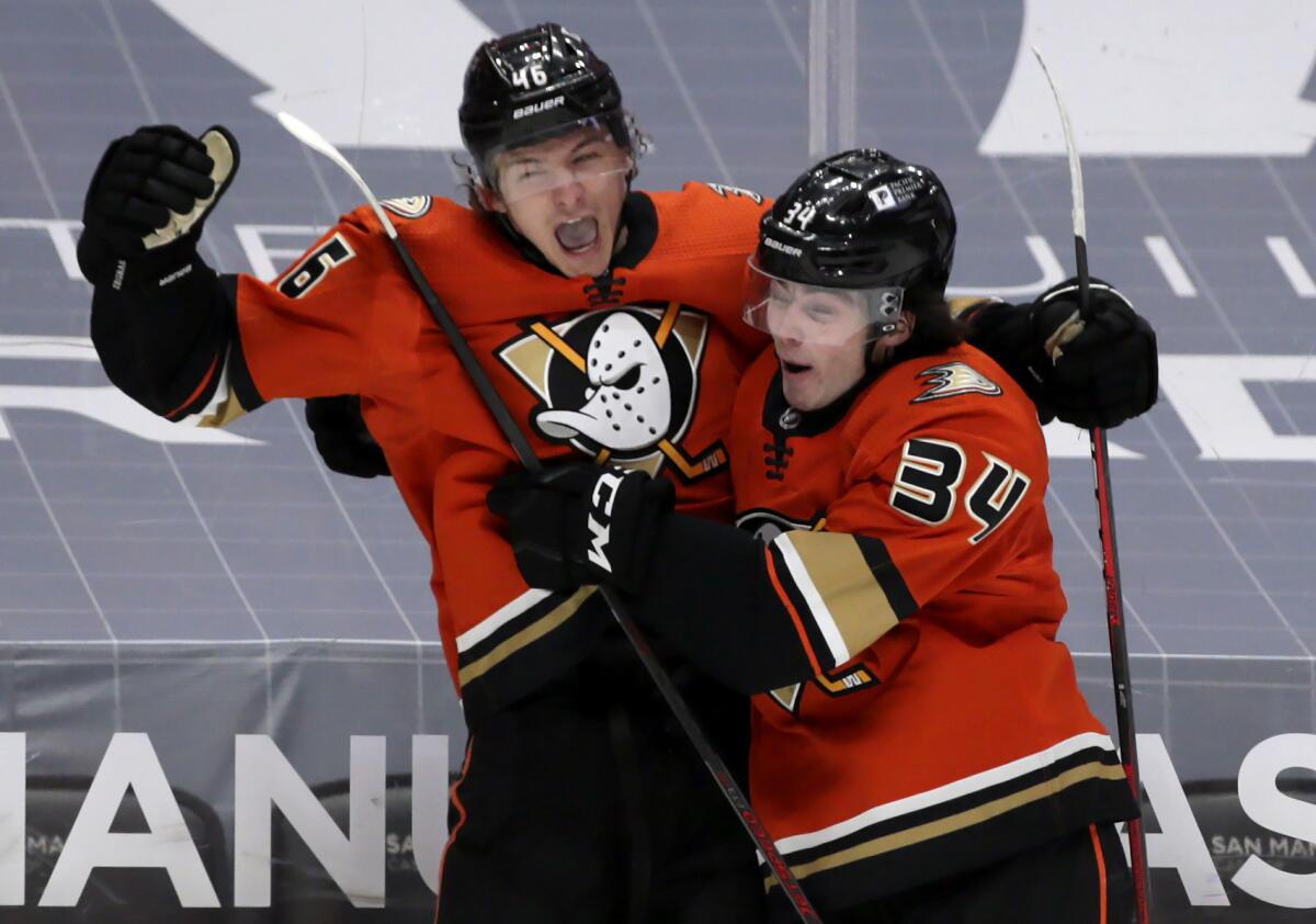 Ducks center Trevor Zegras, left, celebrates with defenseman Jamie Drysdale after scoring his first NHL goal.