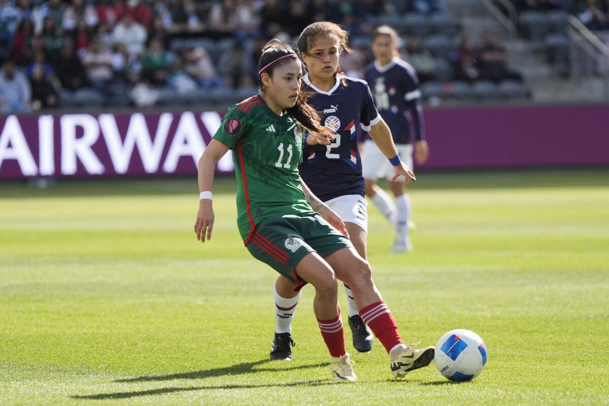 Mexico midfielder Jacqueline Ovalle, left, passes  