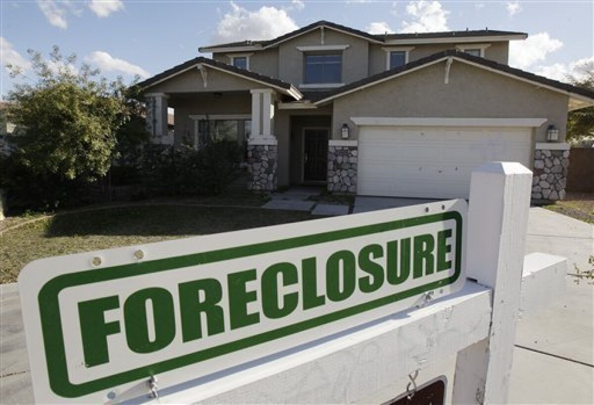 FILE - In this Feb. 17, 2009 file photo, a foreclosure sign sits outside a home for sale in Phoenix. Arizona has one of the highest foreclosure rates in the country. (AP Photo/Ross D. Franklin, File)