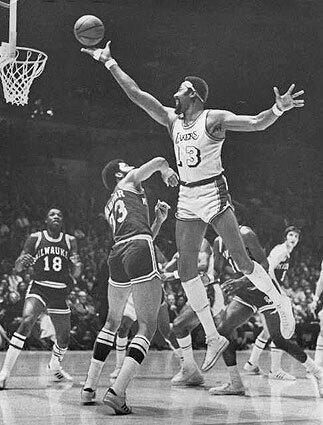 PRELUDE TO SHOWTIME Laker Wilt Chamberlain slides a finger roll over Milwaukee Buck Kareem Abdul-Jabbar during a game in 1972. Abdul-Jabbar, who was known as Lew Alcindor when he played at UCLA from 1965-1969, would follow Chamberlain as Laker center after he returned to Los Angeles in 1975.