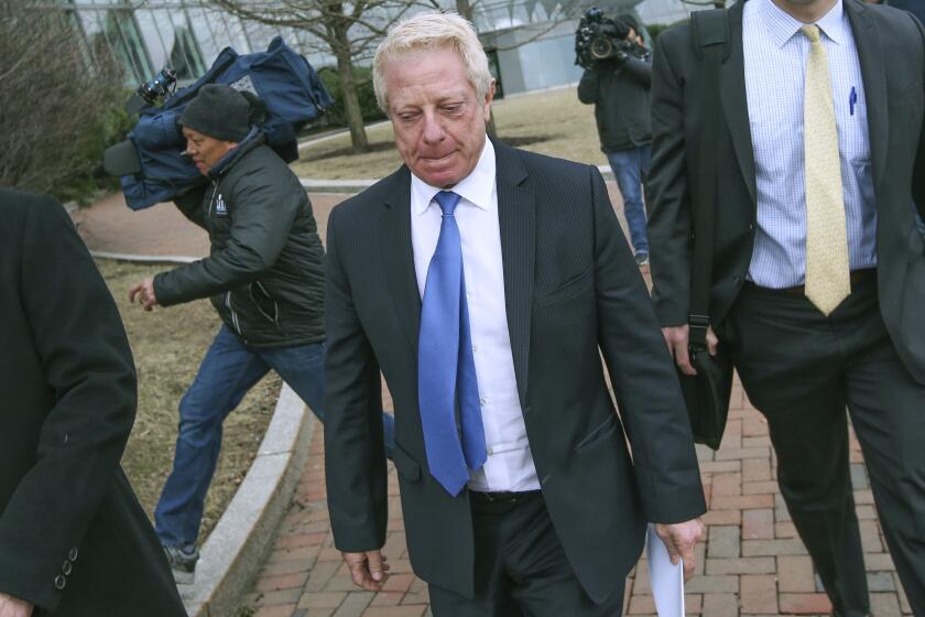 FILE - In this March 29, 2019, file photo, Robert Flaxman, founder and CEO of Crown Realty & Development, leaves the federal courthouse in Boston after a hearing in a nationwide college admissions bribery scandal. Flaxman is scheduled to be sentenced on Friday, Oct. 18. (Nicolaus Czarnecki//The Boston Herald via AP, File)
