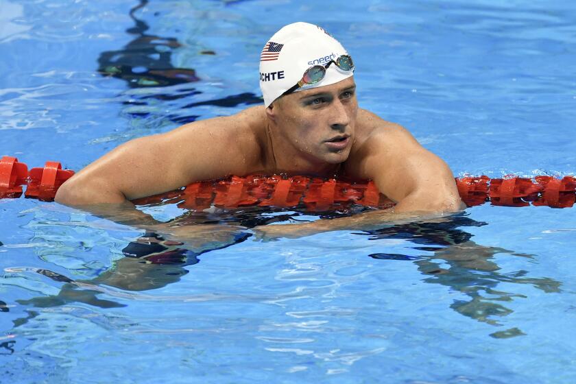 Ryan Lochte checks his time after a freestyle relay heat during the Rio Olympics.