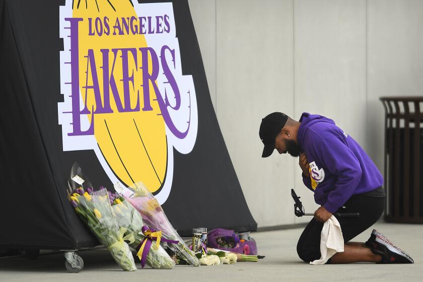 EL SEGUNDO, CALIFORNIA JANUARY 26, 2020-A Lakers fan sobs at a memorial for Kobe Bryant outside the Lakers practice facility Sunday. (Wally Skalij/Los Angeles Times)