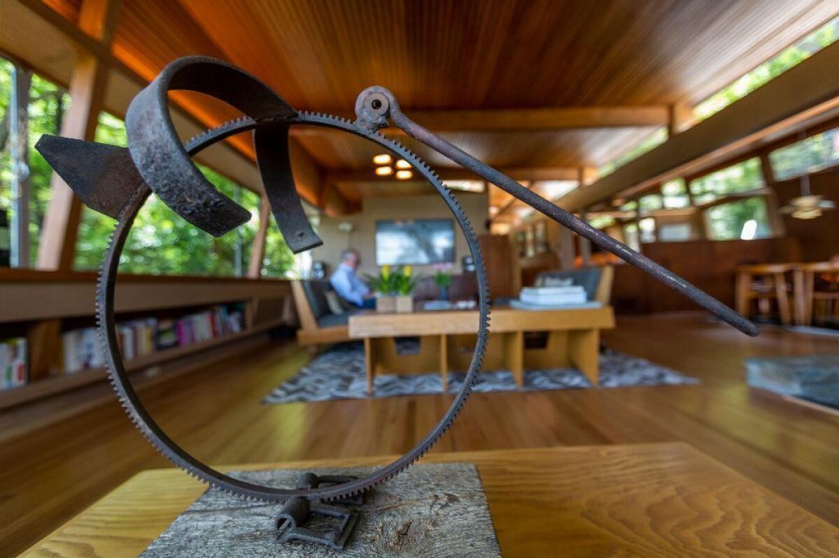 A Japanese sculpture made of iron accents the living room. The home's furnishings are a mix of newly acquired items, longtime possessions and furniture purchased from the estate of a previous owner.