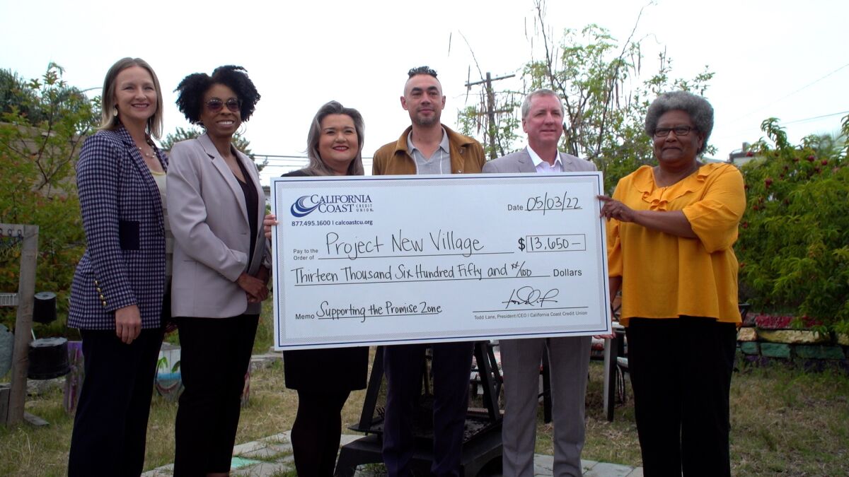 California Coast Credit Union and city of San Diego officials present a microgrant check 