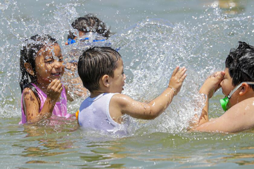 IRWINDALE, CA - JULY 31, 2019 Ñ Children play in swim beach at Santa Fe Dam recreation area on Wednesday afternoon in Irwindale. (Irfan Khan/Los Angeles Times)