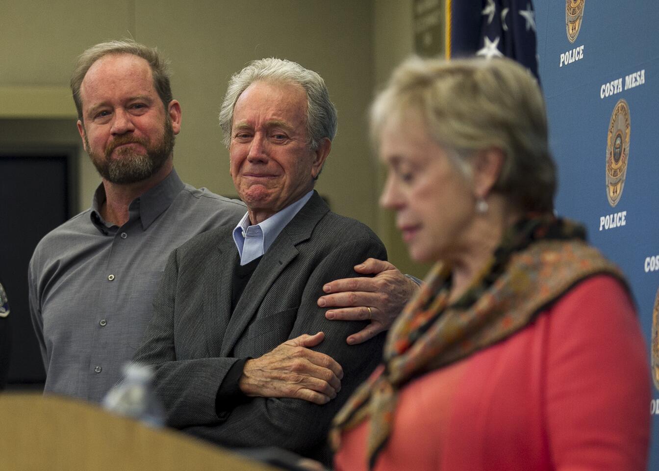 Scott Sudweeks, left, braces his father, Alan, as his mother, Sandy, speaks during a news conference about the 1997 cold-case rape and slaying of his sister Sunny Sudweeks at the Costa Mesa Police Department on Thursday.