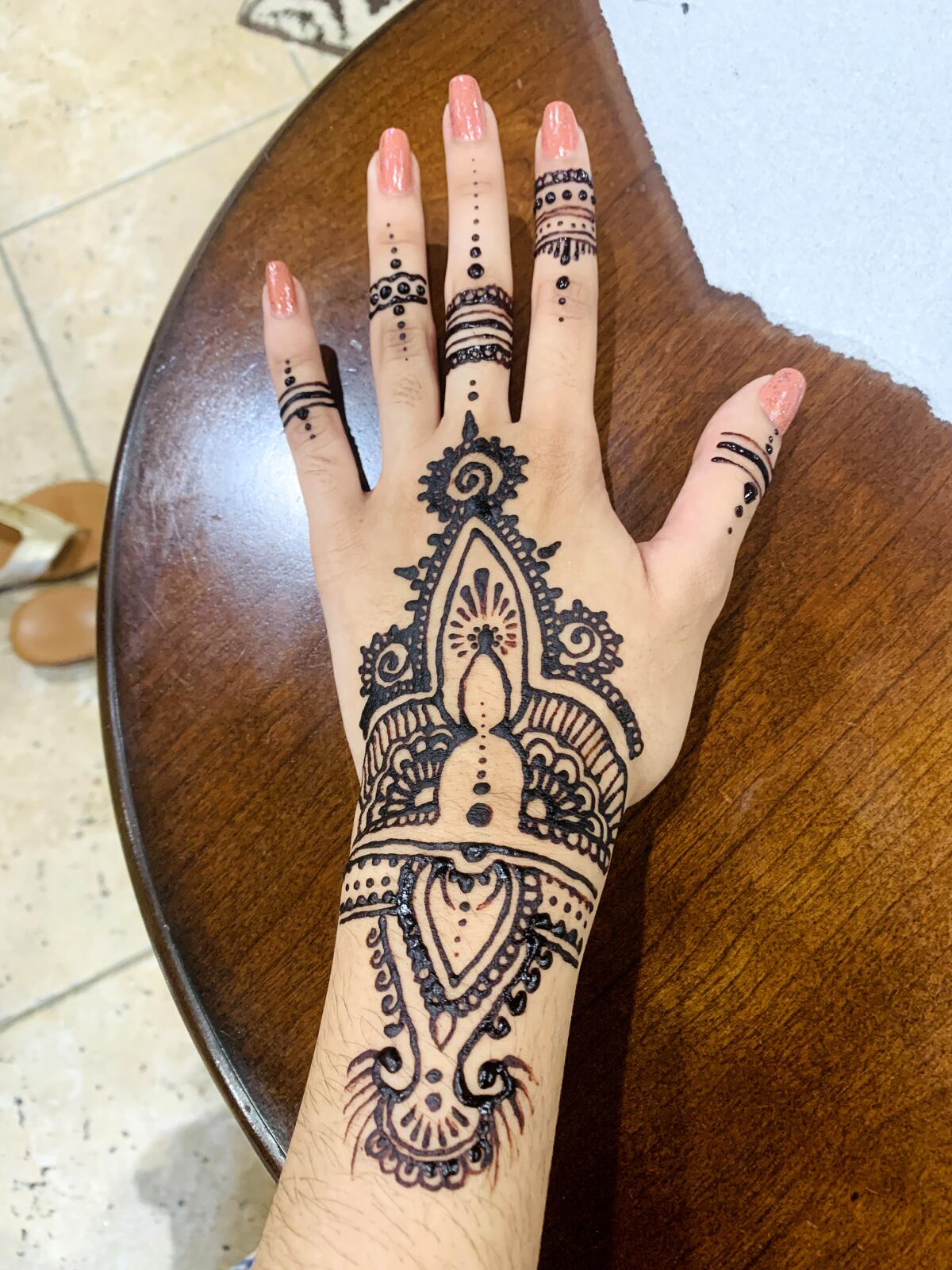 Applying henna with family was one of the first social activities that Sidra Ali was able to engage at home 