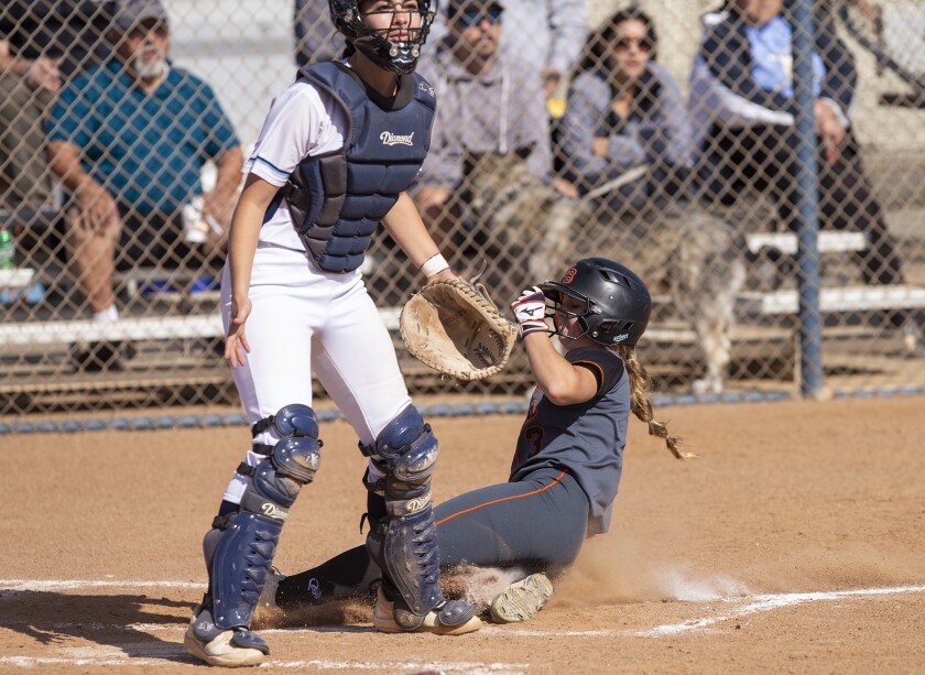 Huntington Beach's Sophia Knight scores on a single by Jaylene Duarte in a Surf League game against Marina on April 19.