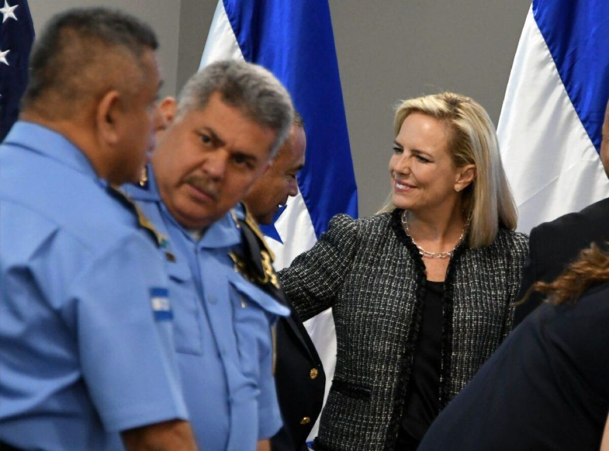 Secretary of Homeland Security Kirstjen Nielsen, right, speaks with Honduran Minister of Security Julian Pacheco.