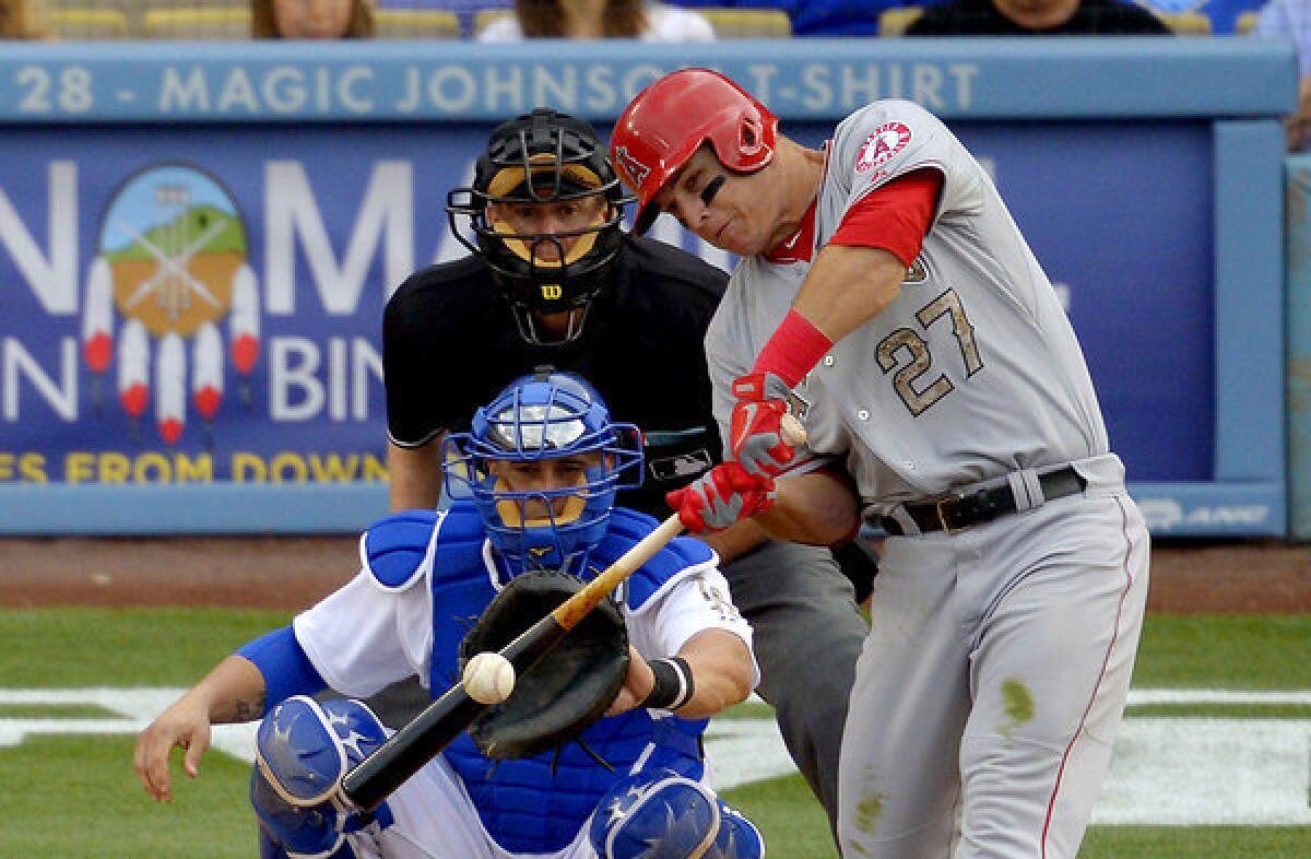 Angels' Mike Trout hits an RBI triple against the Dodgers.