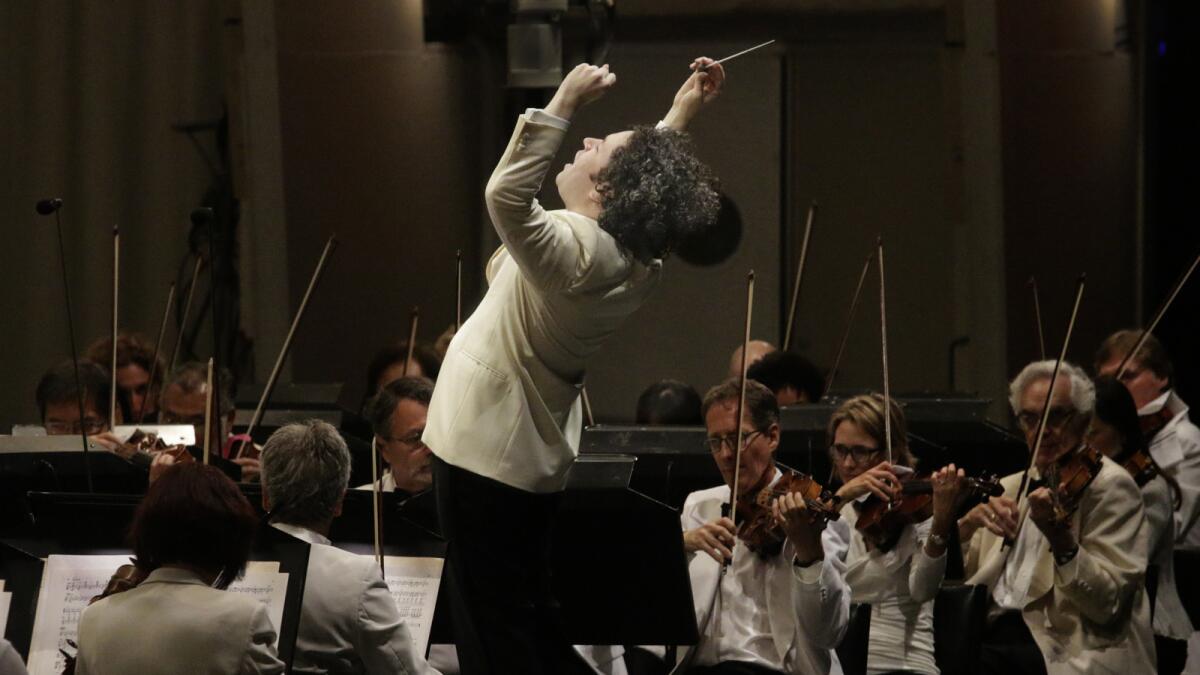 Gustavo Dudamel puts his whole body into Tuesday’s concert with the Los Angeles Philharmonic at the Hollywood Bowl.