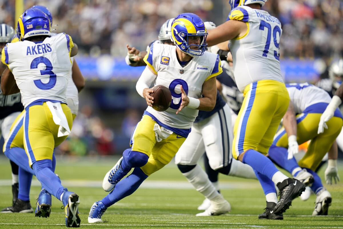Rams quarterback Matthew Stafford keeps the ball for a short gain.