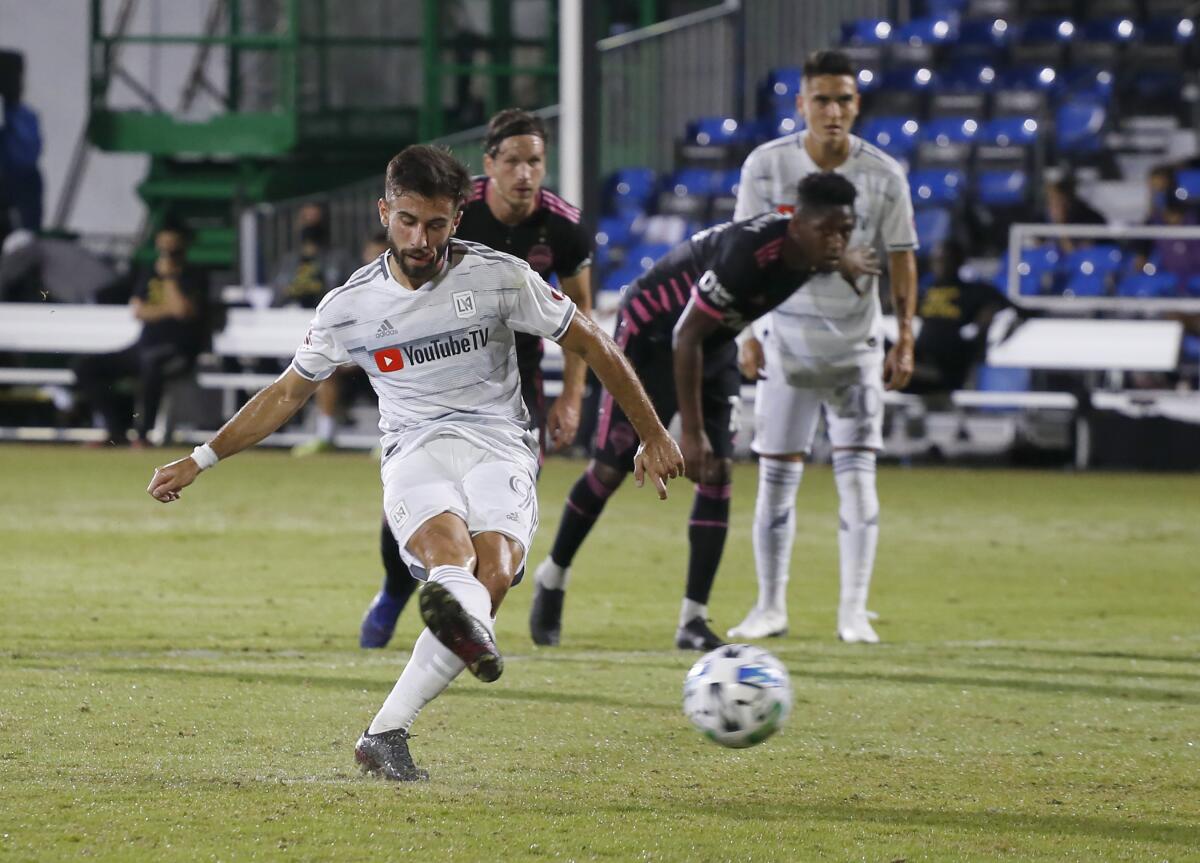 LAFC forward Diego Rossi scores on a penalty kick against the Seattle Sounders during the first half in Kissimmee, Fla.