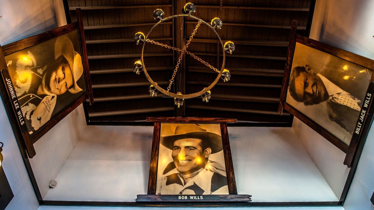 A portrait of Bob Wills, flanked by his brothers, Johnnie Lee and Billy Jack, hangs in the entrance of Cain's Ballroom in Tulsa.
