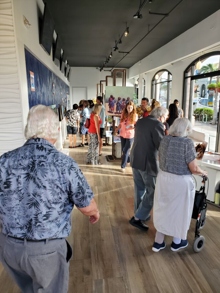 La Jolla First Friday Art Walk visitors view the submissions in the "Circle of Life" art contest and expo.