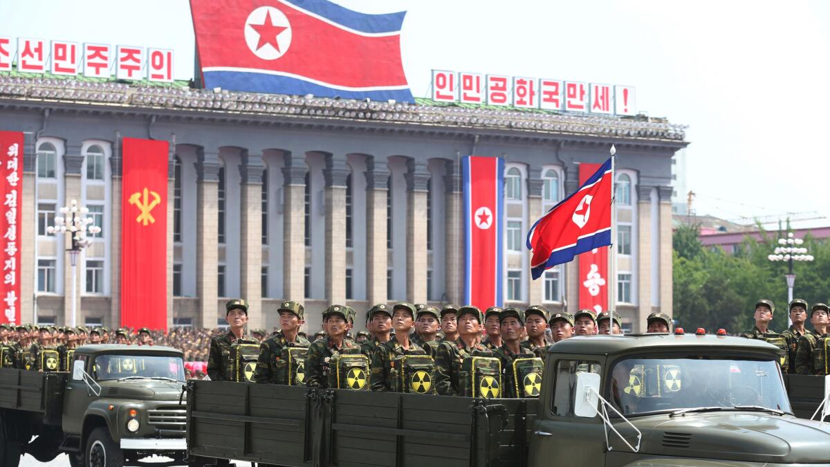 North Korean soldiers turn and look toward leader Kim Jong Un as they parade during a ceremony marking the 60th anniversary of the Korean War armistice in Pyongyang, North Korea, in July 2013.
